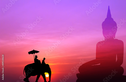 silhouette elephant with tourist with big buddha background at s