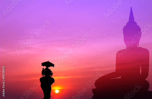 silhouette elephant with tourist with big buddha background at s