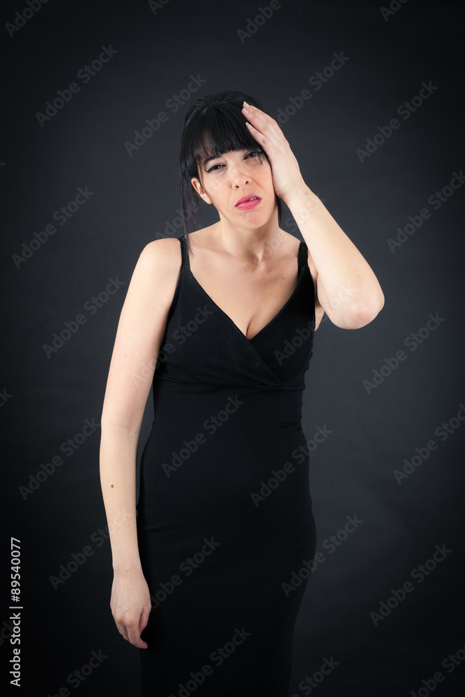 Beautiful woman doing different expressions in different sets of clothes: headache Beautiful woman doing different expressions in different sets of clothes: headache