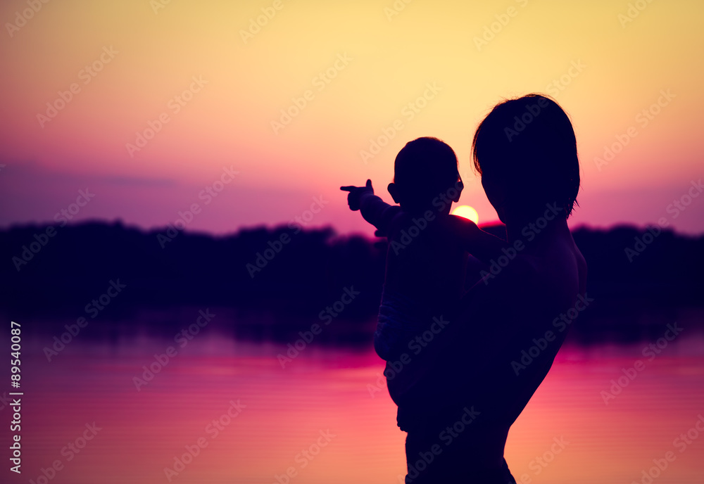 Silhouettes of Father and Baby Watching Sunset