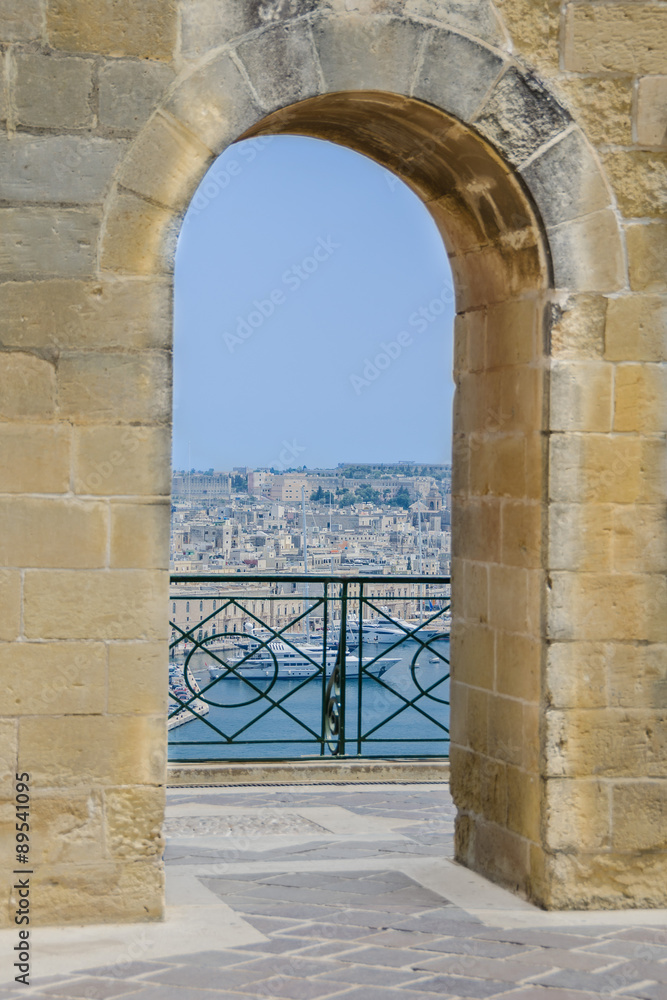 Waterfront views through arched passageway