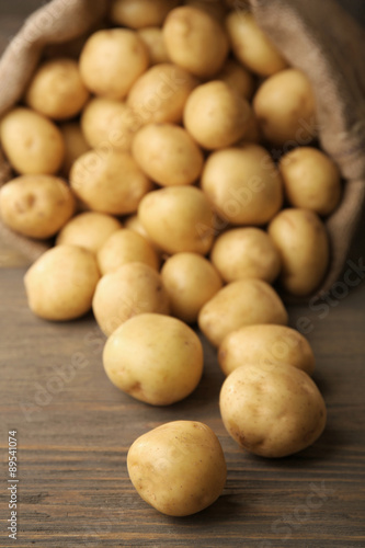 New potatoes on wooden table  closeup