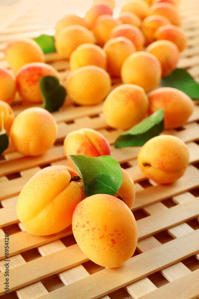 Ripe apricots on wooden lattice background Ripe apricots on wooden lattice background