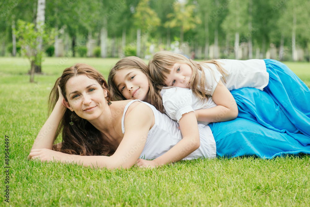 Mother with children spending free time playing outdoors Mother with children spending free time playing outdoors