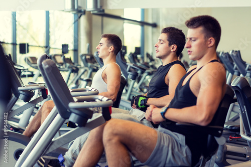 men working out on exercise bike in gym