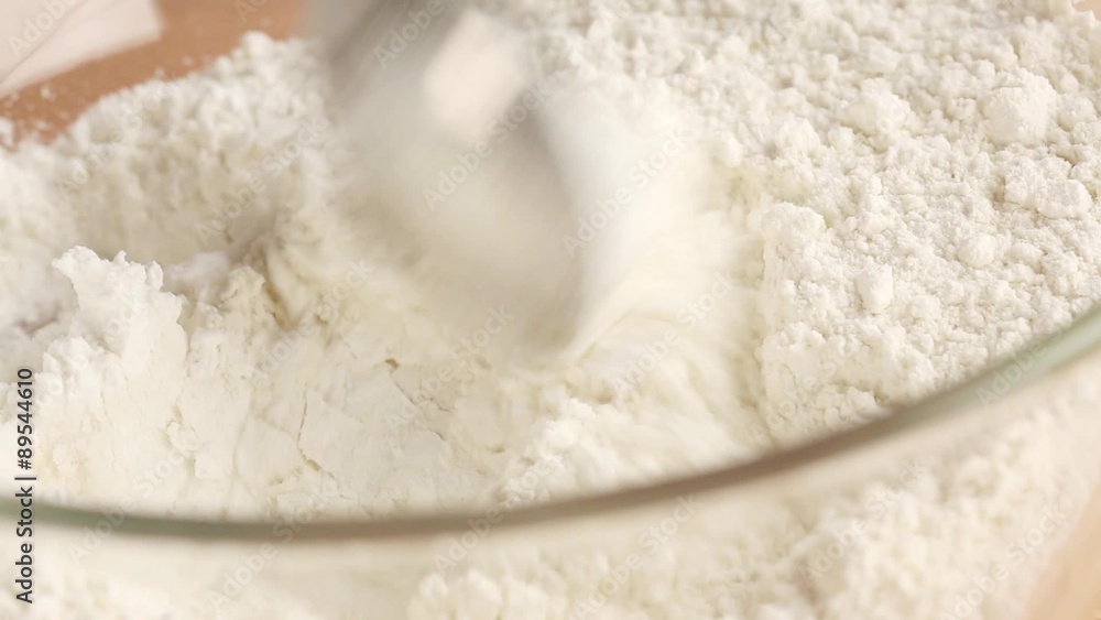 Baking powder being added to flour Baking powder being added to flour