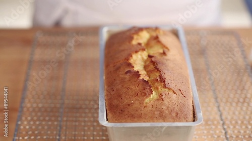 Testing a loaf cake with a wooden stick photo