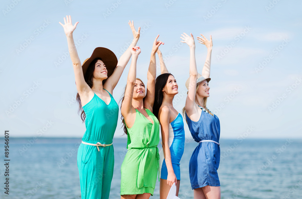 girls looking at the sea with hands up girls looking at the sea with hands up