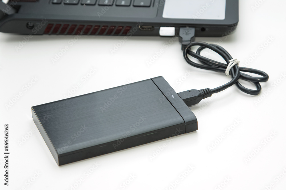external hard disk connect to computer notebook on white. external hard disk connect to computer notebook on white.