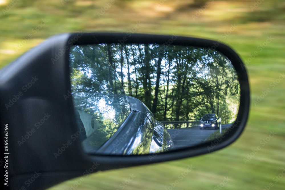 car with distance in driving-mirror