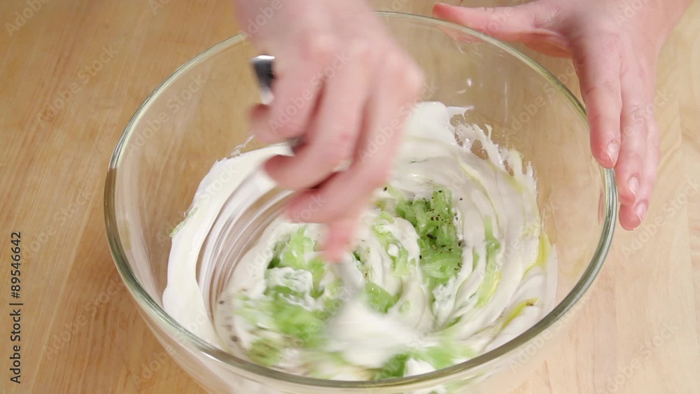 Ingredients for tzatziki being mixed together Ingredients for tzatziki being mixed together
