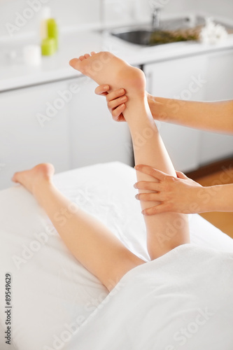 Young Woman Receiving Leg Massage at Spa Center. Body Care