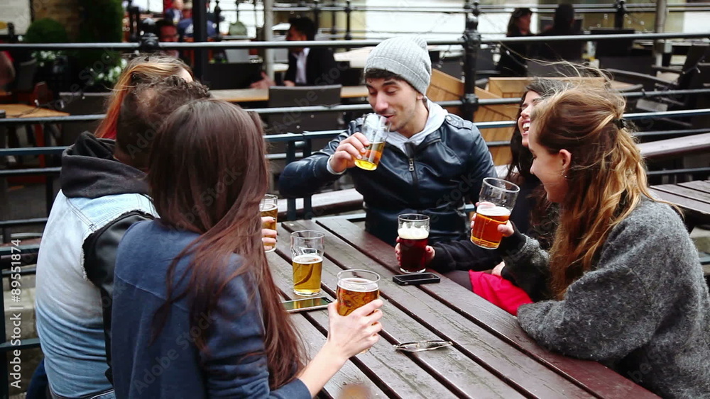 Group of friends enjoying a beer at pub in London
Group of friends enjoying a beer at pub in London