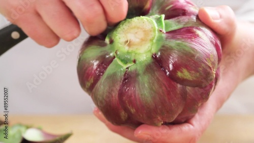 Removing lower leaves from artichokes