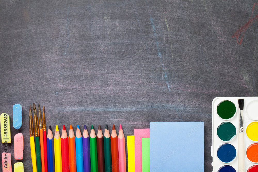 School supplies on blackboard background School supplies on blackboard background