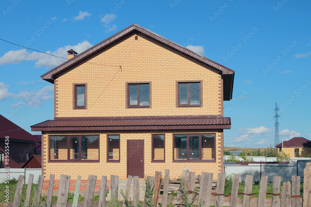 New not populated country house behind an old fence New not populated country house behind an old fence