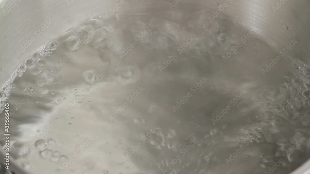 Placing chopped potato into boiling water Placing chopped potato into boiling water