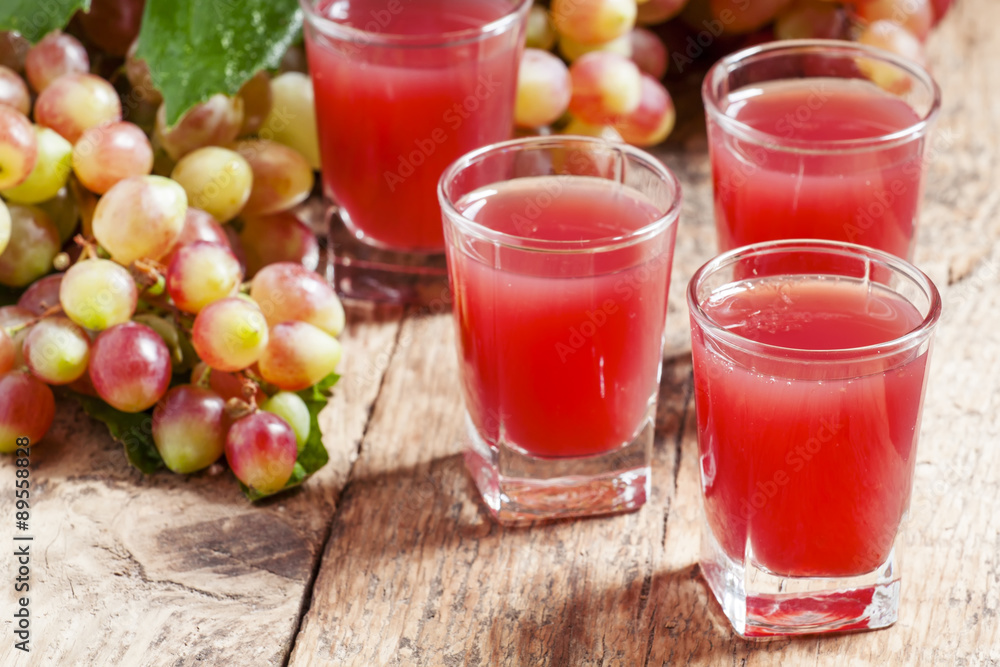 Grape juice pink grapes with fresh berries, selective focus Grape juice pink grapes with fresh berries, selective focus