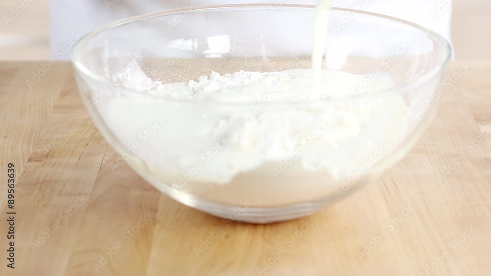 Buttermilk being added to a flour and vegetable fat mixture Buttermilk being added to a flour and vegetable fat mixture