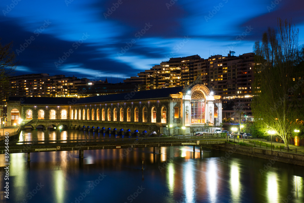 The BFM (Batiment des Forces Motrices) and the Rhone river at the blue hour, Geneva, Switzerland. This state owned building was formerly a power generating plant, it is now an opera house.