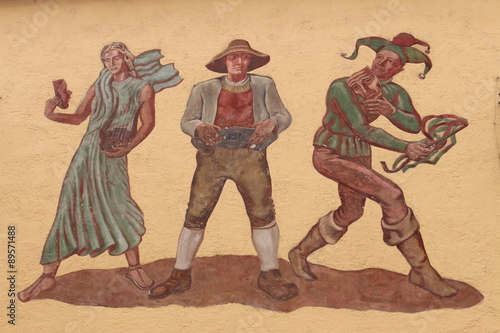 Historical murals with three human figures on a wall on Wallpachgasse street in Hall in Tirol, Austria. 