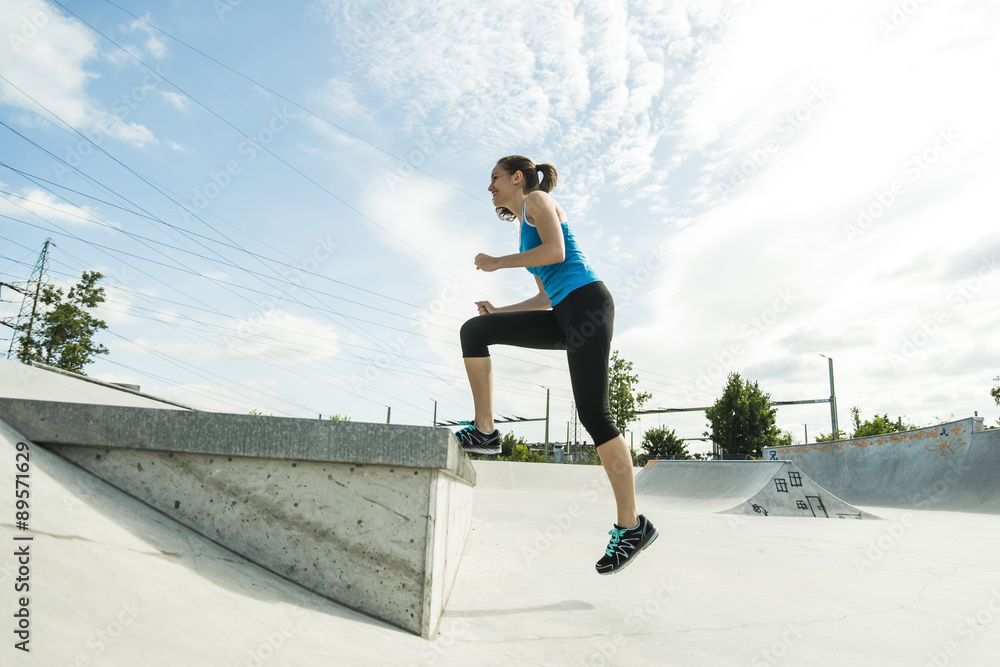 Sportive young woman training in a skate park Sportive young woman training in a skate park