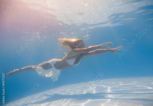 Young woman swimming underwater