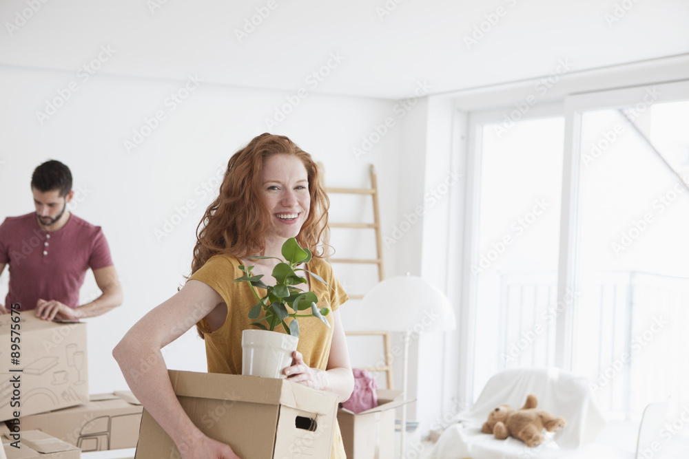Young couple in new flat unpacking cardboard boxes Young couple in new flat unpacking cardboard boxes