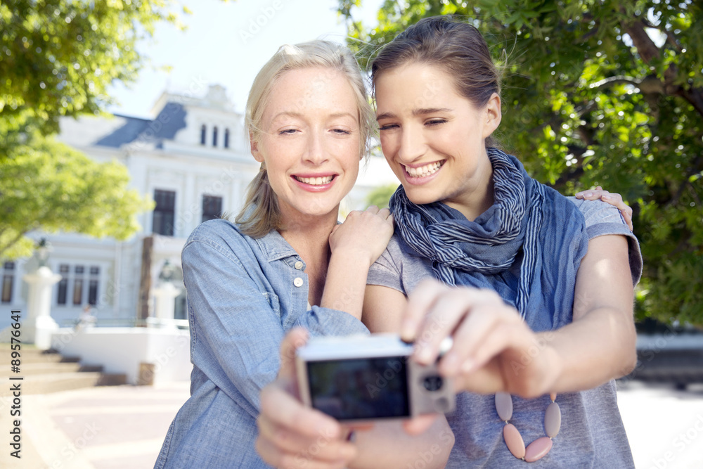 Two young women outdoors taking a selfie Two young women outdoors taking a selfie