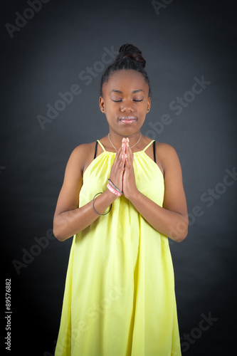 Beautiful girl doing different expressions in different sets of clothes: prayer