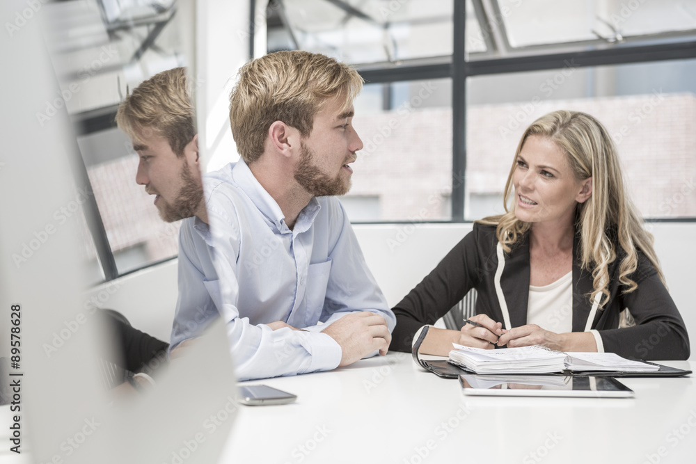 Businessman and businesswoman having an office meeting Businessman and businesswoman having an office meeting