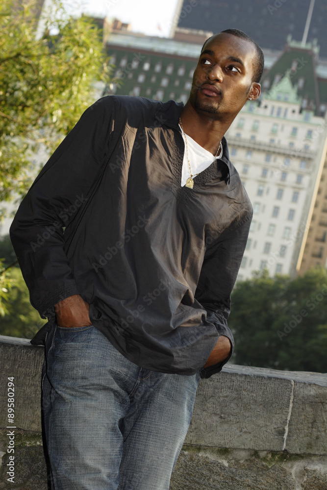 Young man stands on bridge in Central Park. Young man stands on bridge in Central Park.