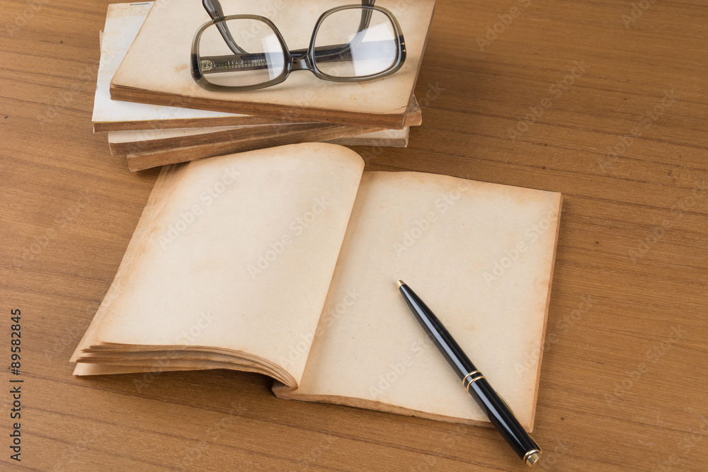 Fototapeta premium old book on wood table