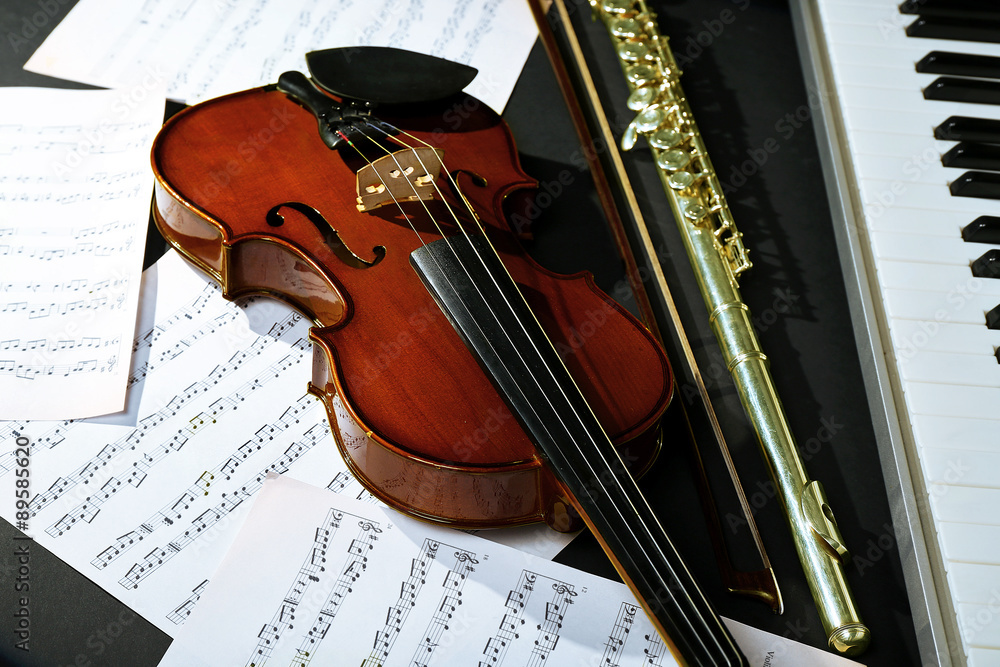 Fototapeta premium Musical instruments with music notes on dark background