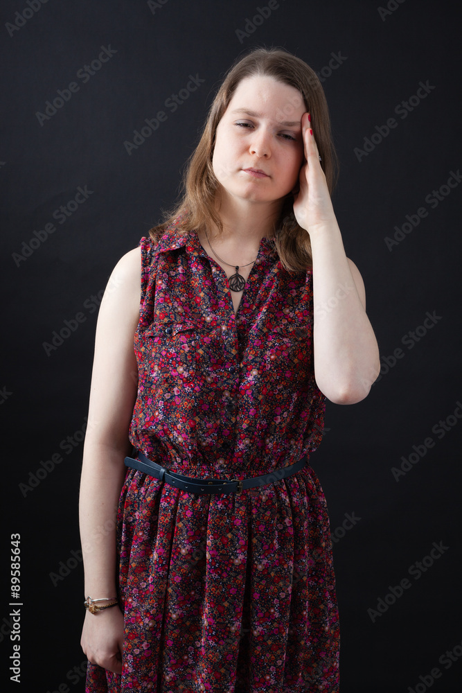 Beautiful woman doing different expressions in different sets of clothes: headache Beautiful woman doing different expressions in different sets of clothes: headache