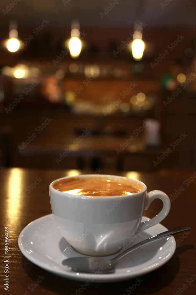 Cup of latte coffee on wooden table in cafe Cup of latte coffee on wooden table in cafe