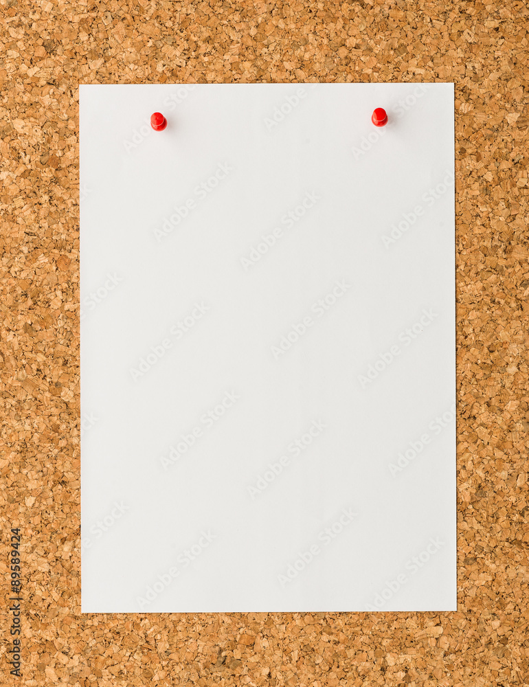 white paper note sheet with red push pin on cork board white paper note sheet with red push pin on cork board