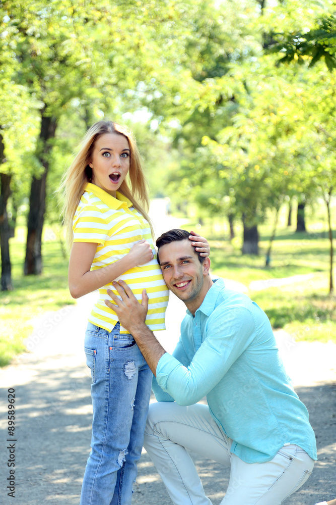 Fototapeta premium Young pregnant woman with husband in park
