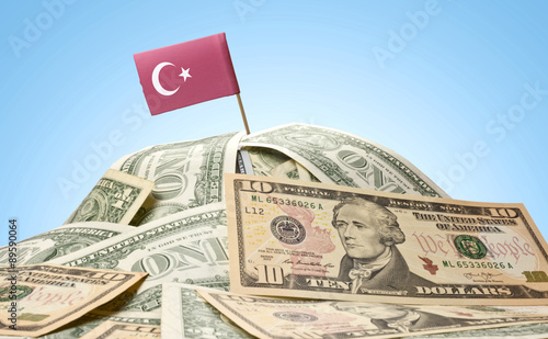 Flag of Turkey sticking in a pile of american dollars.(series)
