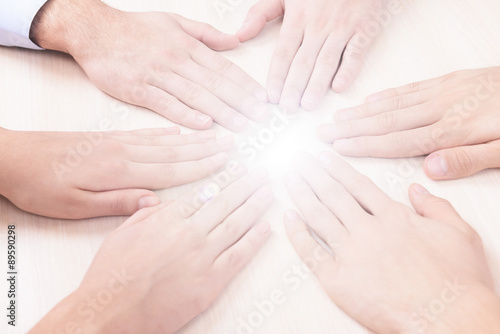 Many hands with light © Africa Studio