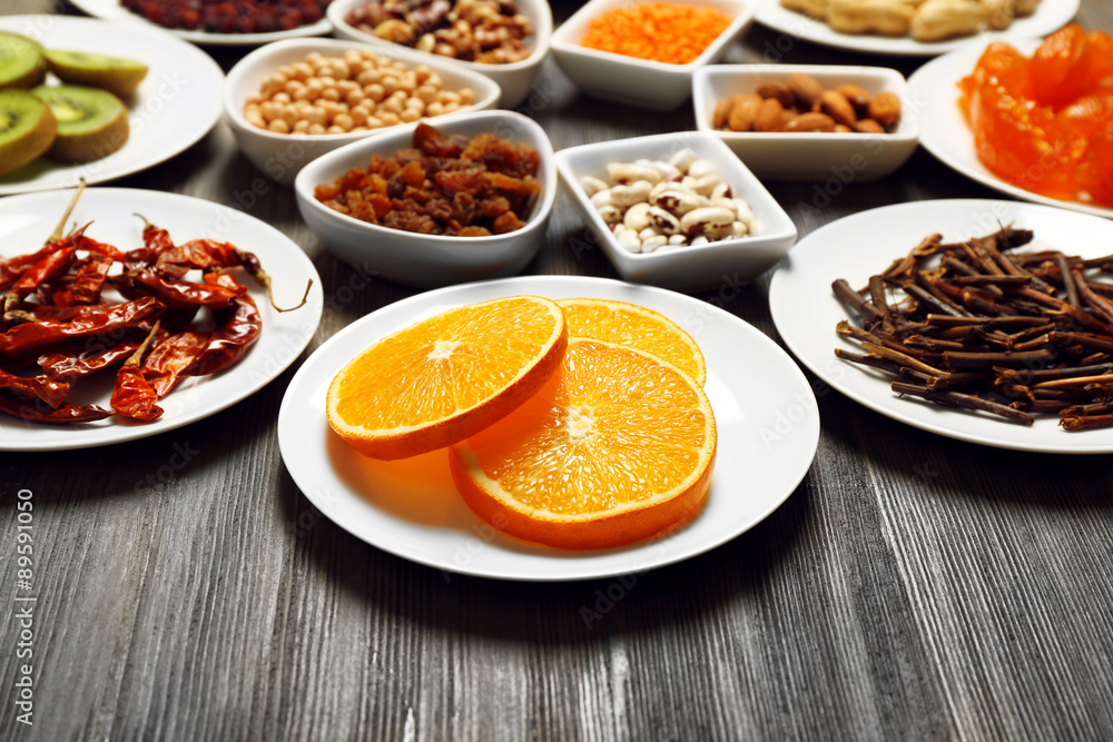 Different products on saucers on wooden table, closeup Different products on saucers on wooden table, closeup