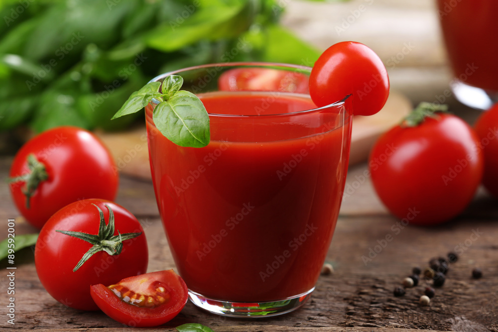 Glass of tomato juice on wooden table, closeup Glass of tomato juice on wooden table, closeup