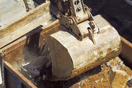 bulldozer excavator machine vehicle picks up debris