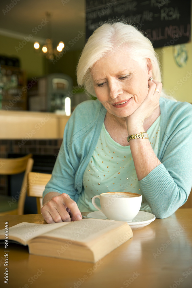 Portrait of senior woman reading book in a cafe Portrait of senior woman reading book in a cafe