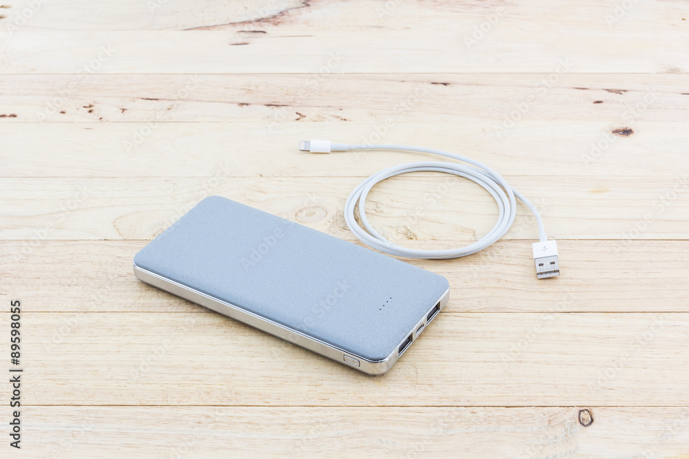 Grey powerbank and USB cable for smartphone. Grey powerbank and USB cable for smartphone.