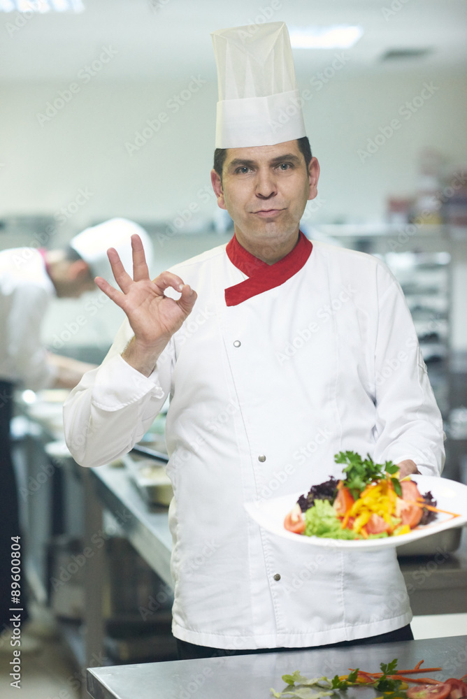 chef in hotel kitchen preparing and decorating food chef in hotel kitchen preparing and decorating food