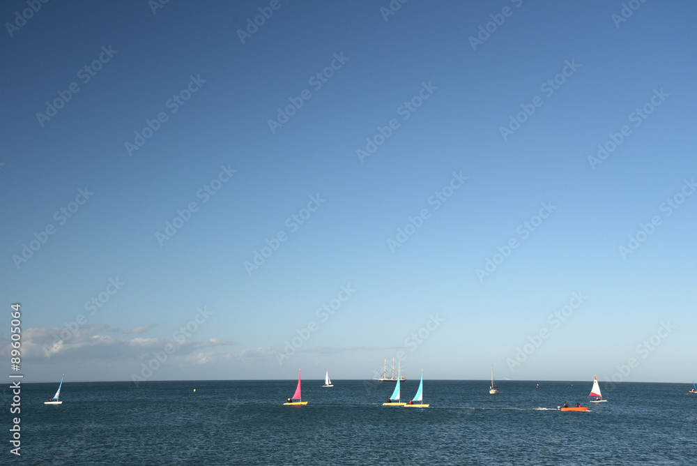 Obraz premium Yachts at sea off Swanage beach in Dorset