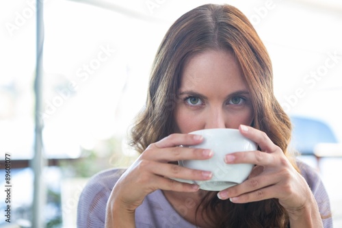 Pretty brunette enjoying a cappuccino 