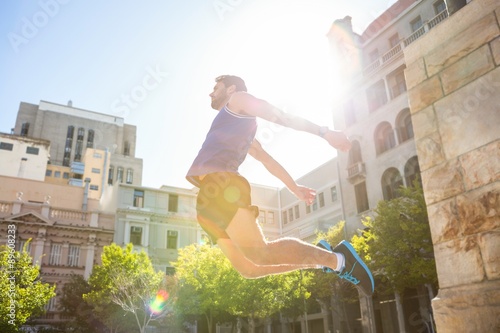 Handsome athlete jumping 