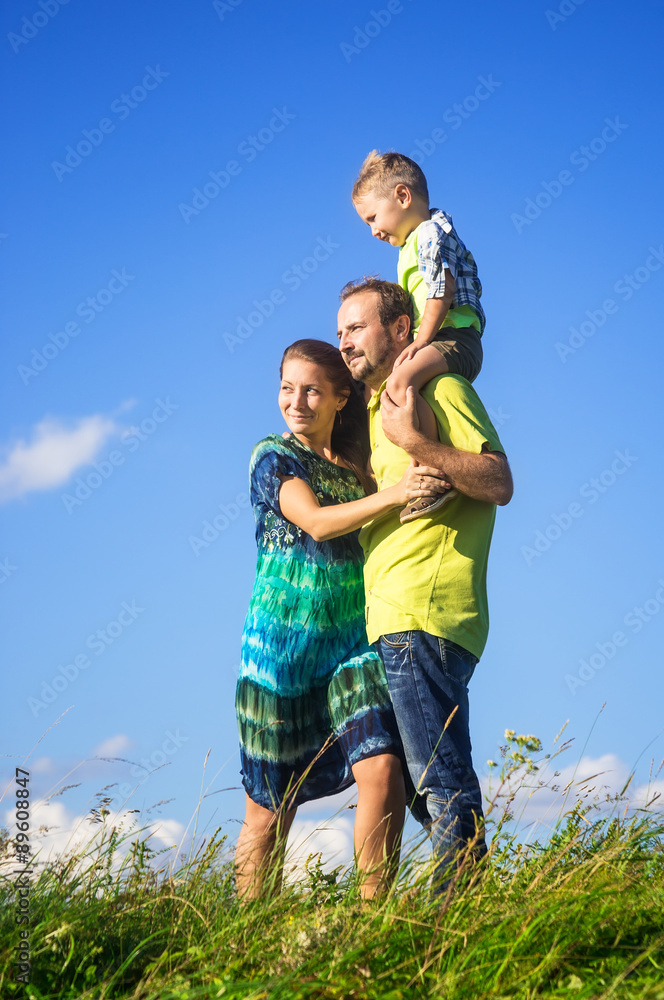 Happy family from three people have fun outdoors